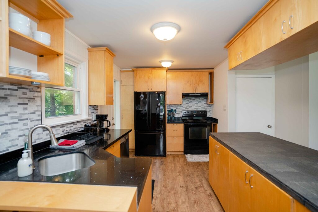 Full kitchen in the lower unit with modern cabinetry