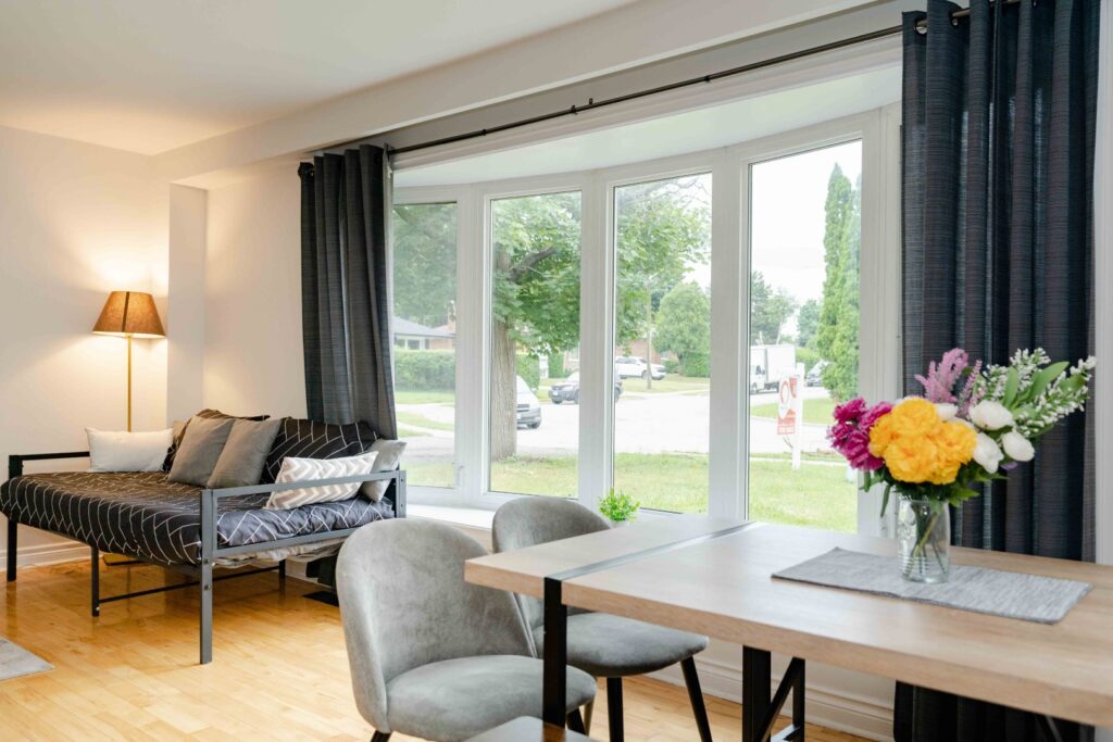 Lower unit hallway and living area with bright lighting