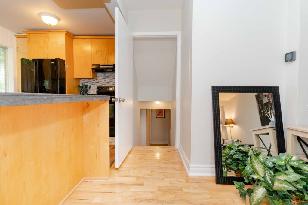 Lower unit hallway and living area with bright lighting