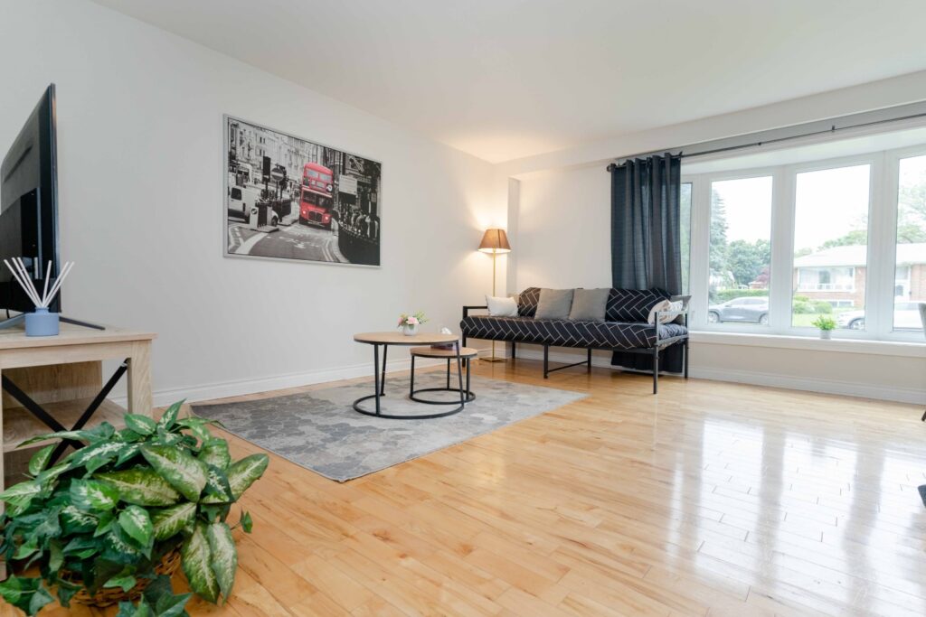 Lower unit hallway and living area with bright lighting