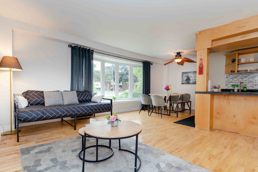 Lower unit hallway and living area with bright lighting